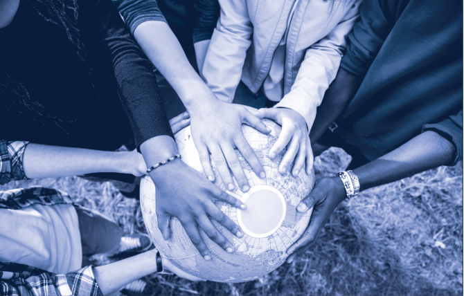 Various hands on a globe featuring multiple races