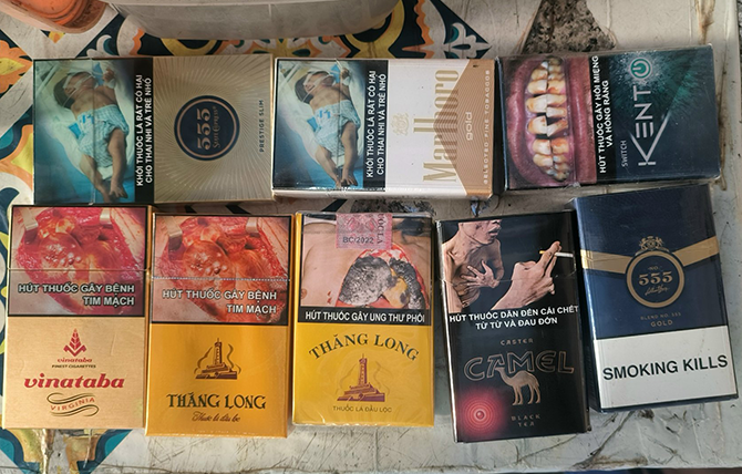 Cigarette packs displayed on a table in Vietnam